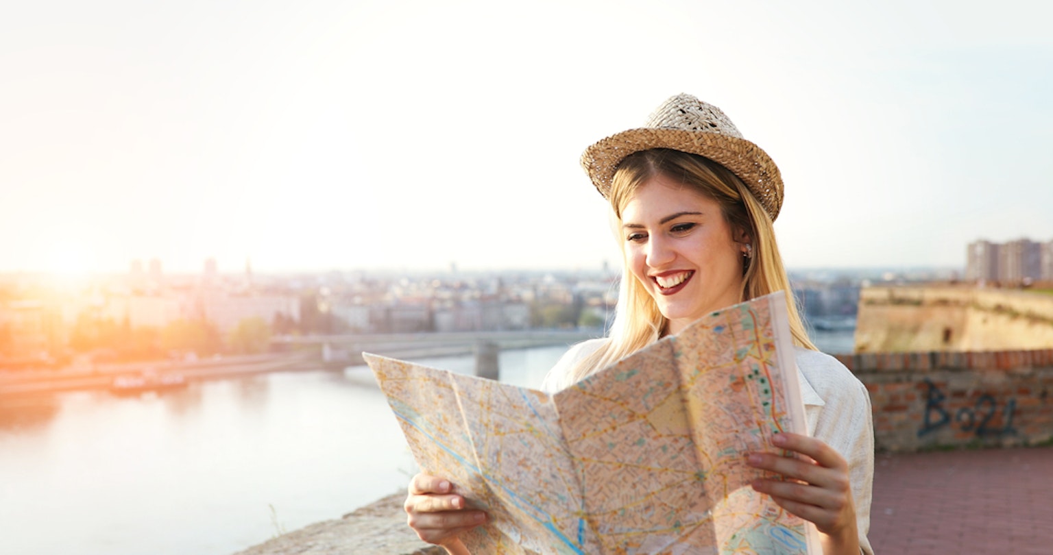 Tourist woman holding travelers map